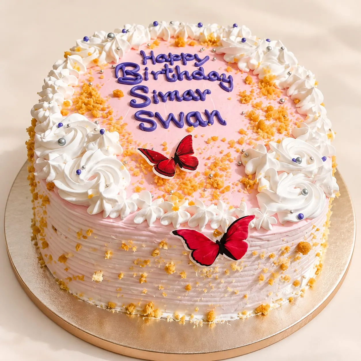Blush pink birthday cake with white cream swirls, red butterflies and a name piped in violet